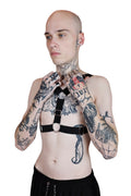 Adjustable men's harness designed to be worn two ways, with bold straps and durable construction for rave wear.