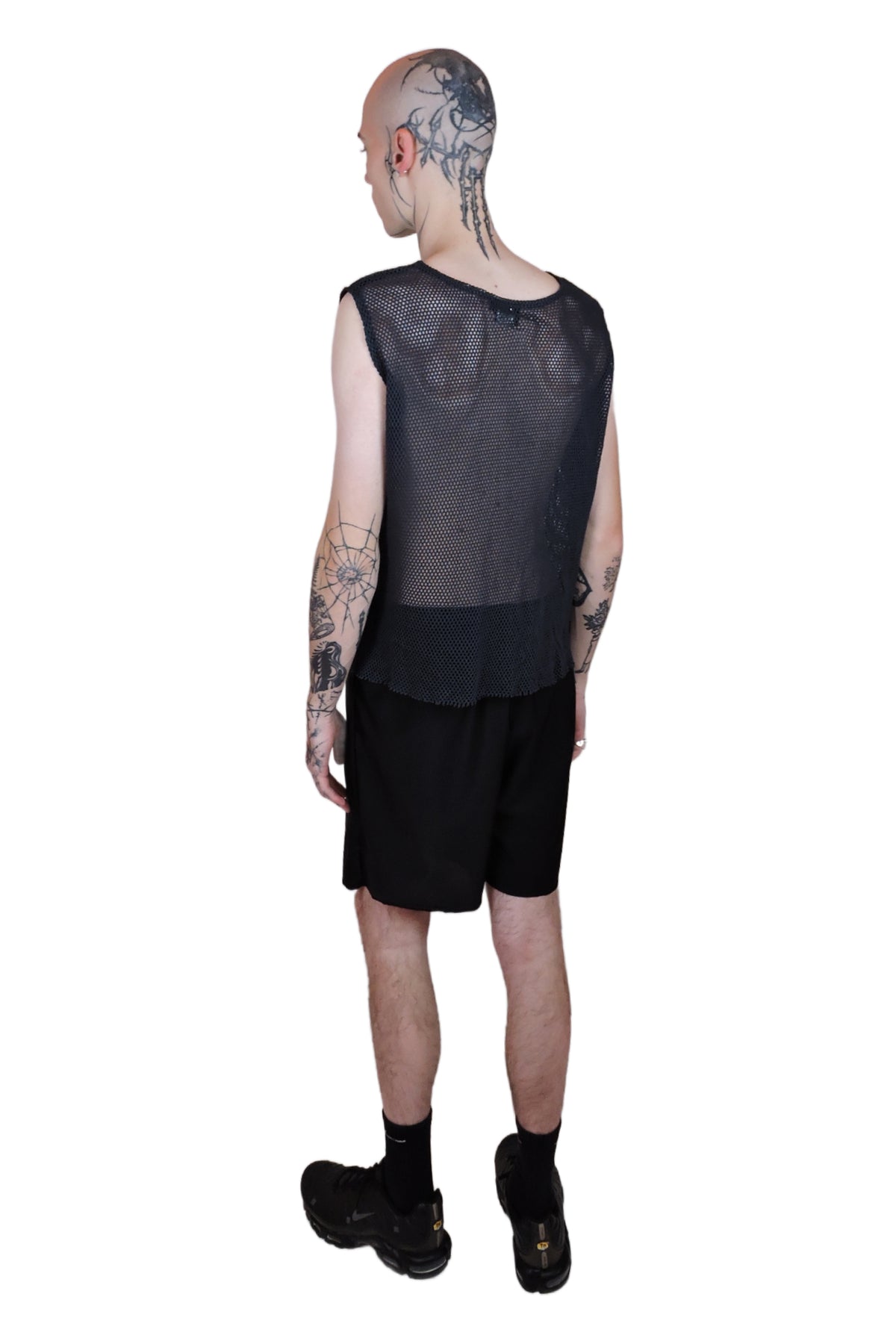 Men's black organic cotton net top featuring a bold silver ring accent at the front, blending edgy style with sustainable design. Back view