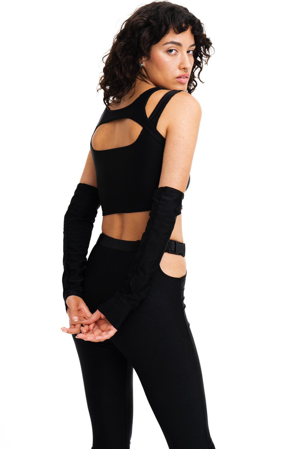 Black flared leggings with hip cutouts and chunky buckles.