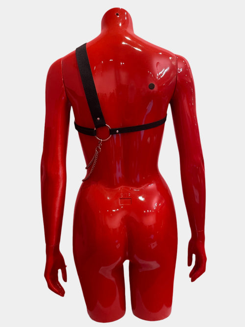 An asymmetric unisex harness crafted from thick black bands and silver chains, designed for a bold and unconventional statement, shown from the back.