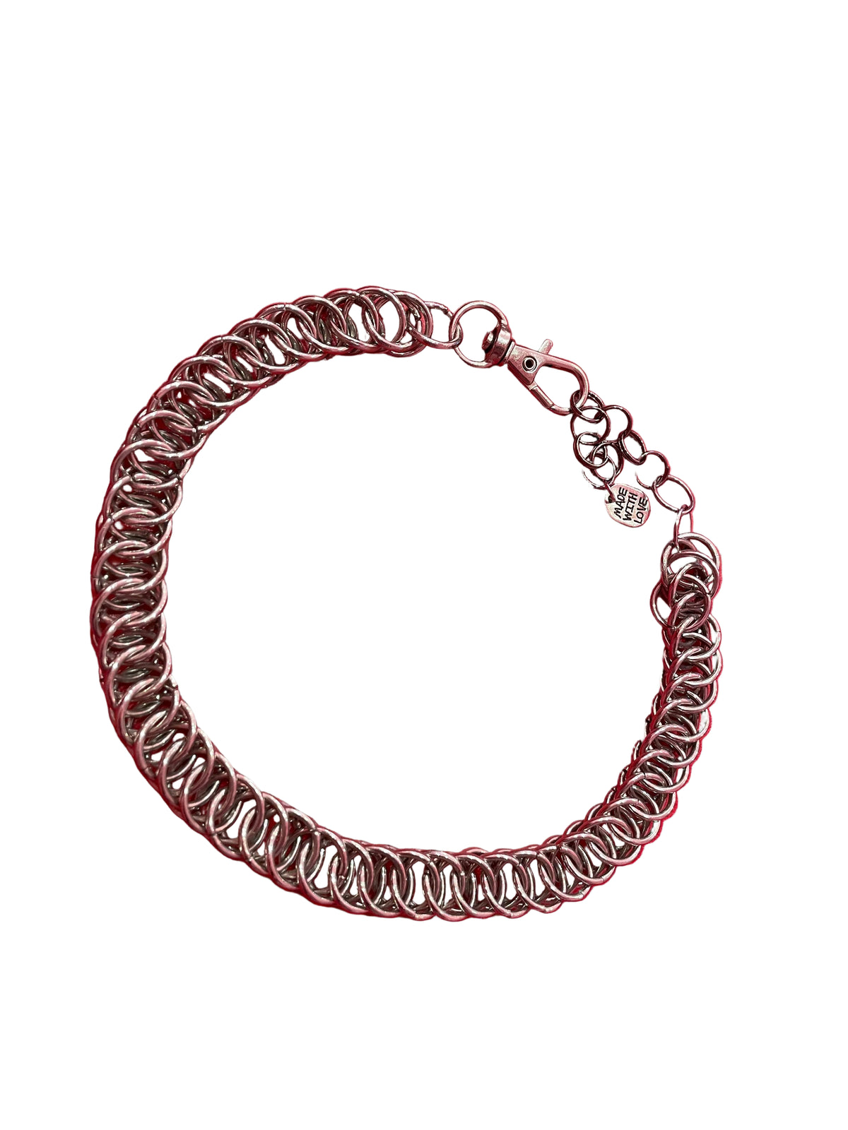 A close-up of a simple yet stunning chain mail choker, featuring a delicate and intricate weave. The choker rests gracefully against a neutral backdrop, showcasing its elegant and versatile design.