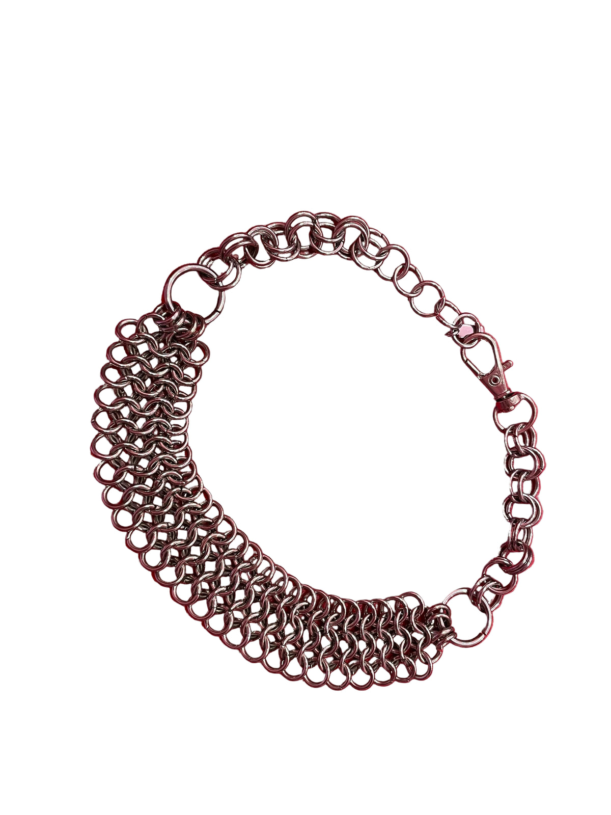 A close-up of a chunky yet lightweight silver chain mail choker, featuring intricate links. The choker rests against a neutral background, showcasing its bold design and adjustable clasp.