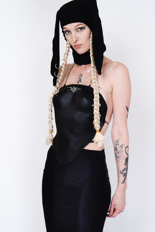 Black knit balaklava with bunny ears and a silver piercing.