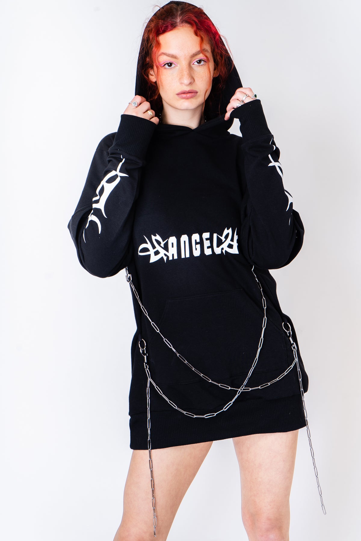 Black oversized hoodie with tribal print and chain detailing.