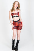 Bright red and black rave shorts with hip cutouts.