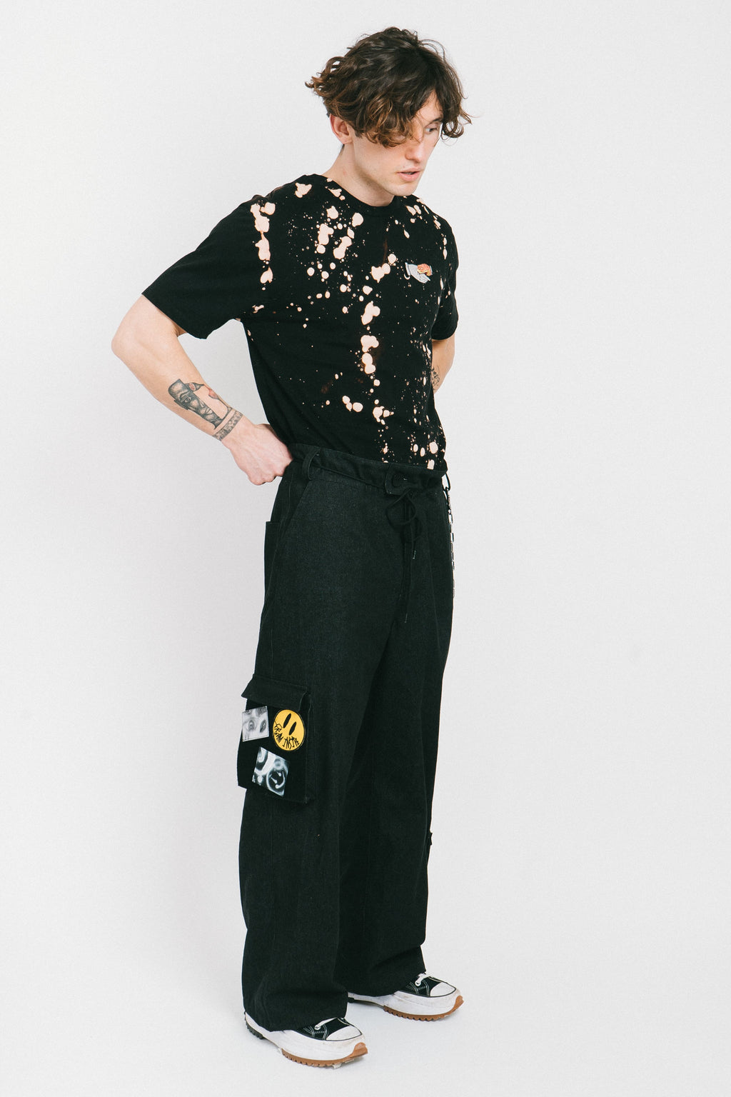 Black cotton bleached men's tshirt with a tatoo style patch.
