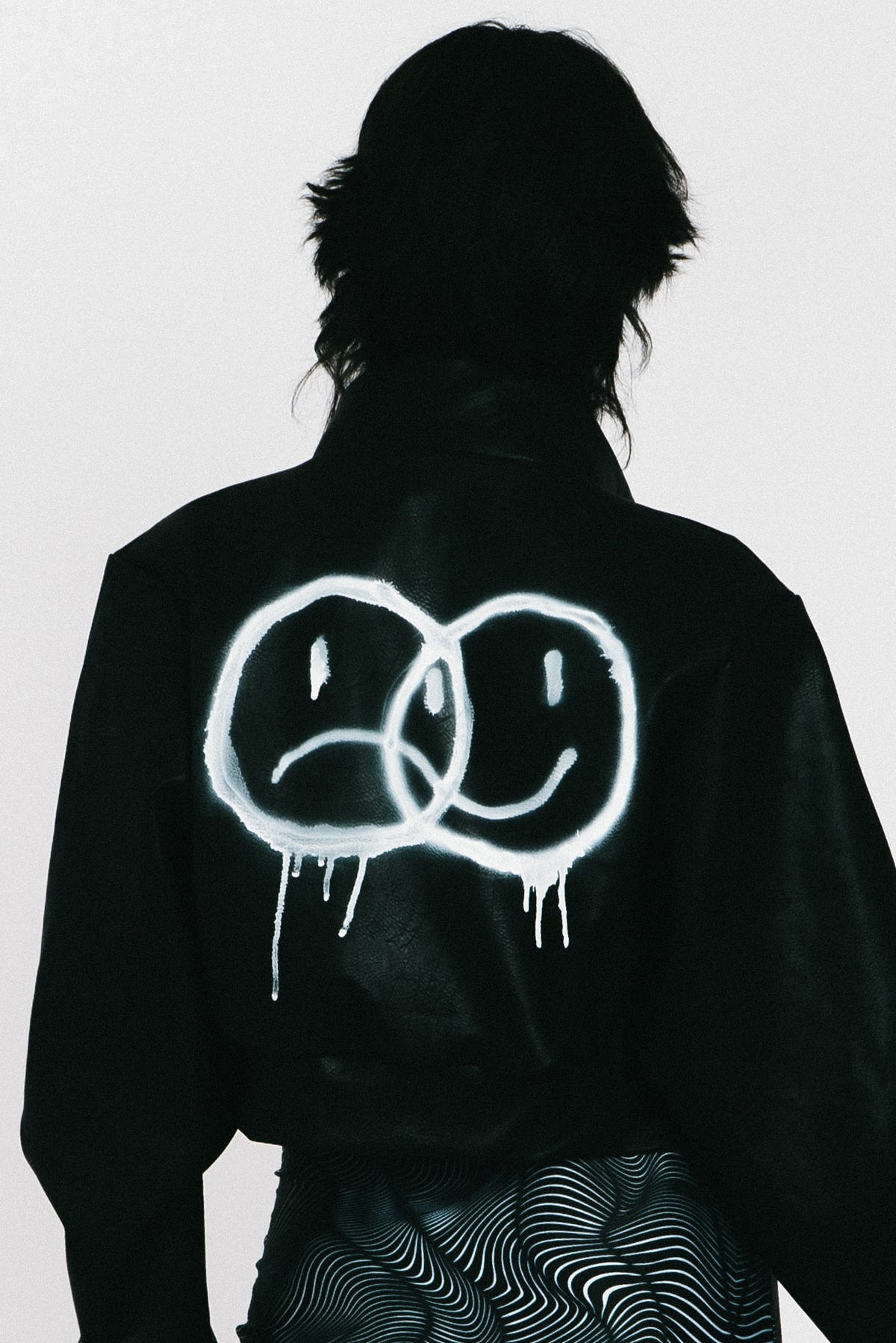 Vegan leather jacket with smileys on the back and red lining from IVY Berlin
