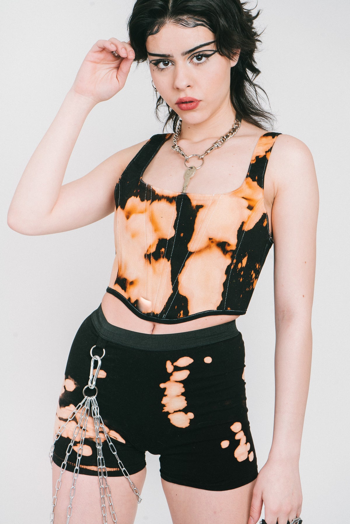 Tight black and bleached cotton short with silver chain hardware.