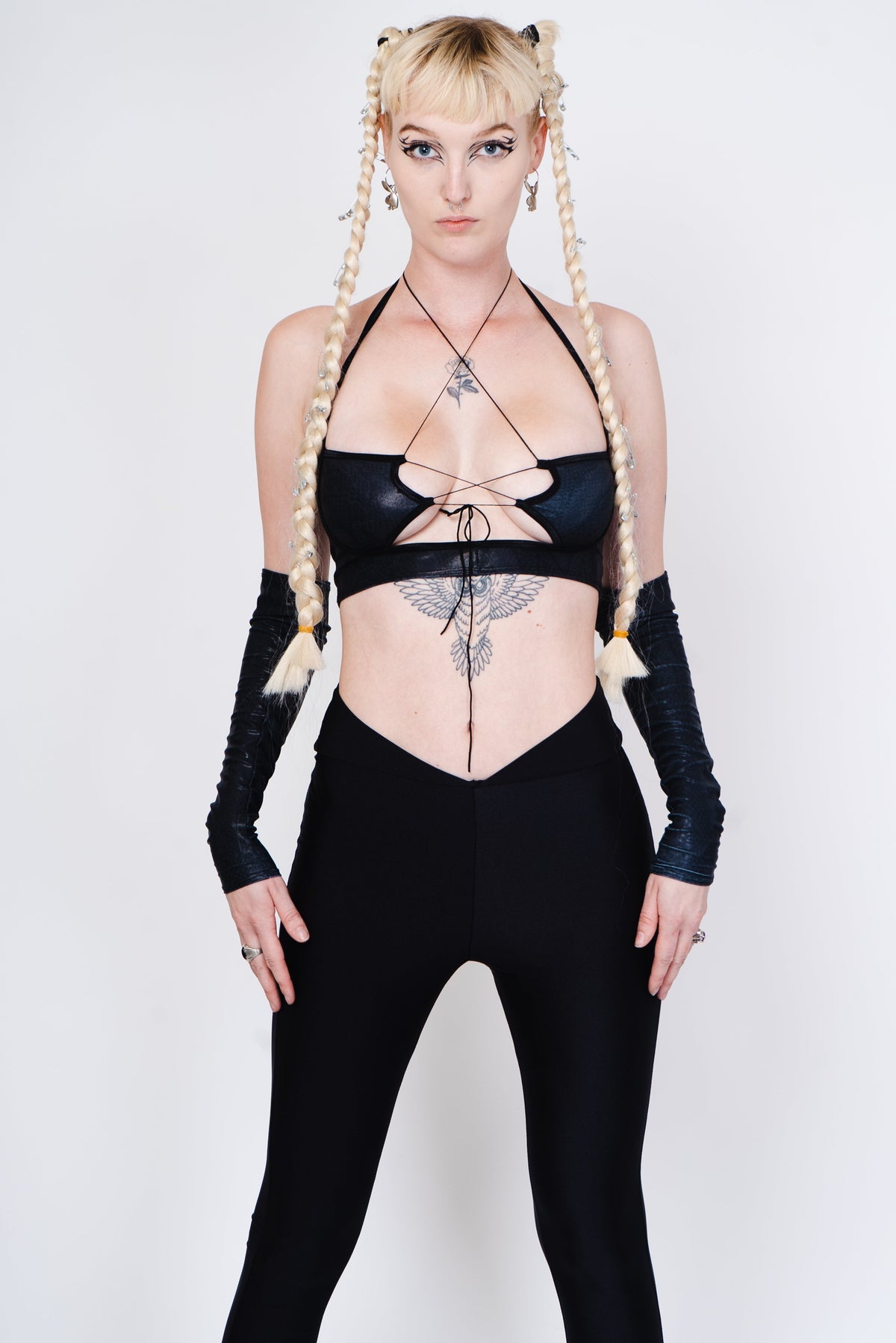 Black flared leggings with a tribal tattoo on the back in an alternative goth style.