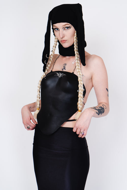Black knit balaklava with bunny ears and a silver piercing.