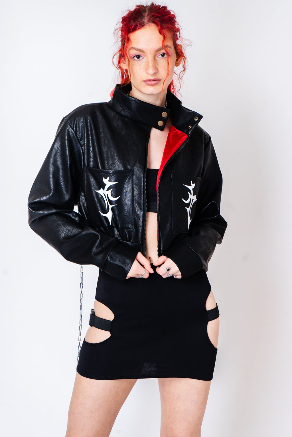 Black vegan leather jacket with silver chains and a tattoo print.