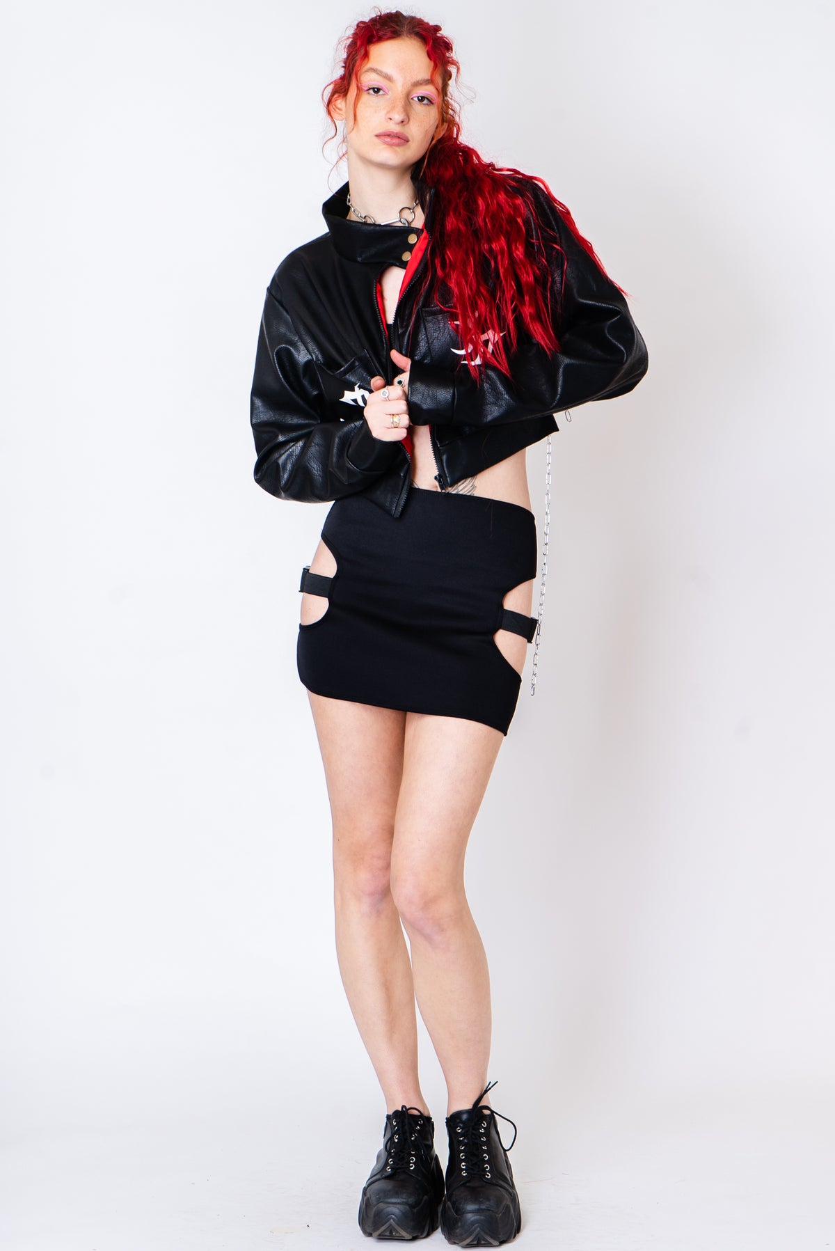 Black vegan leather jacket with silver chains and a tattoo print.