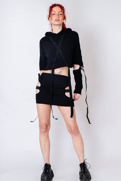 Black strappy hoodie with cutouts and silver hardware.